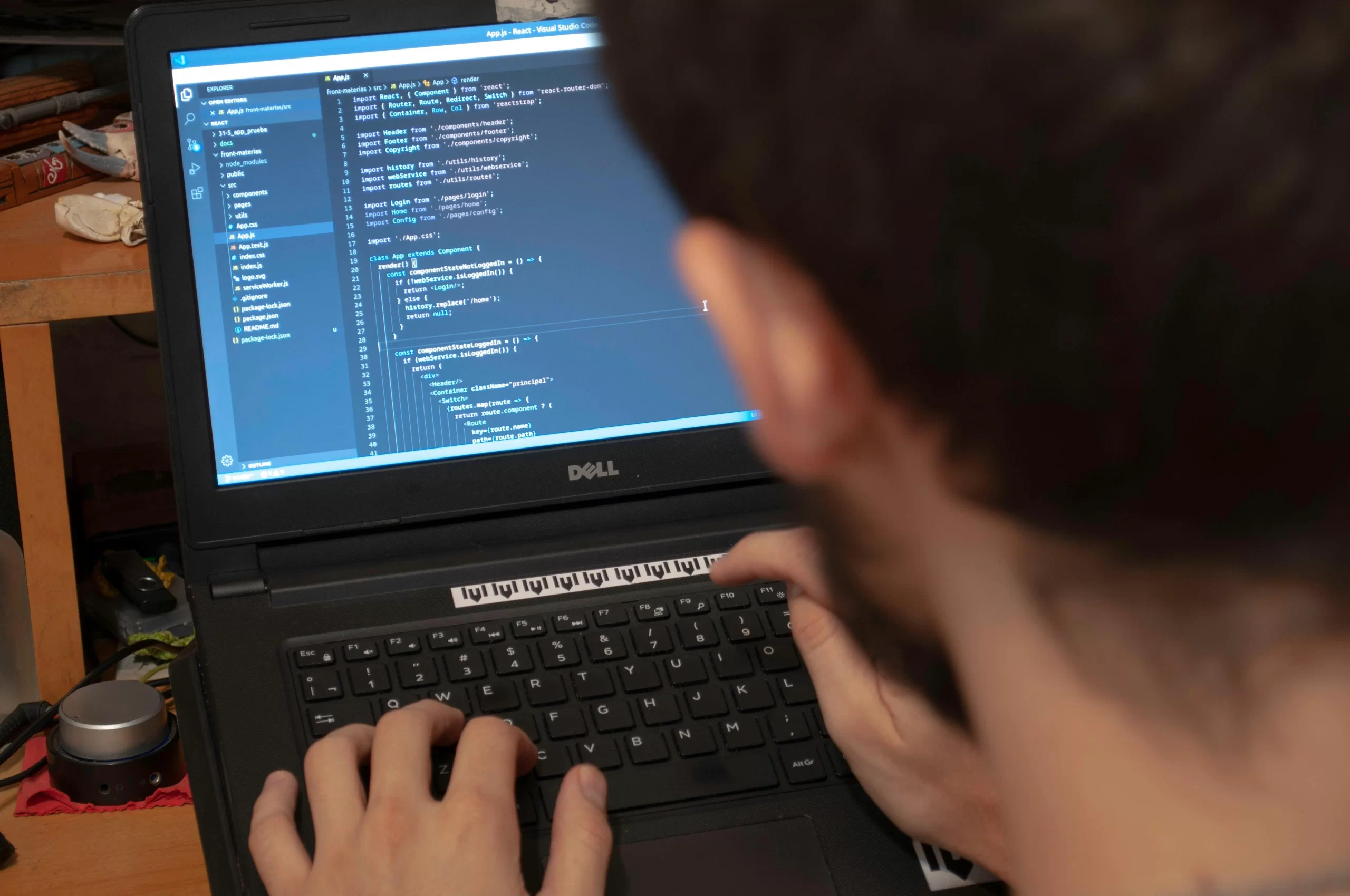A developer coding on a laptop.