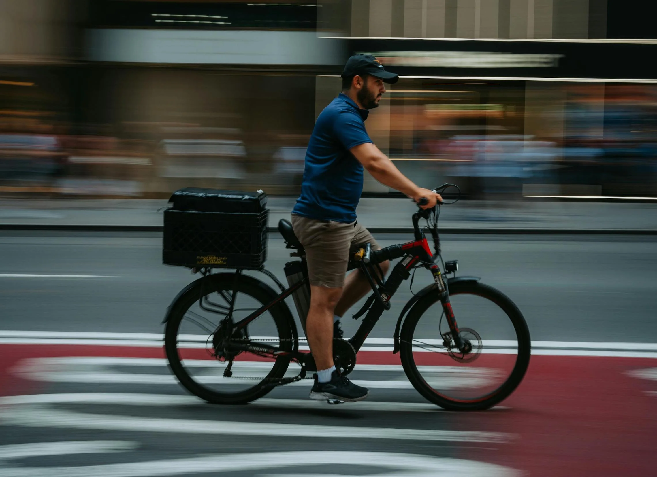 New York Delivery worker riding an E-bike on a street.