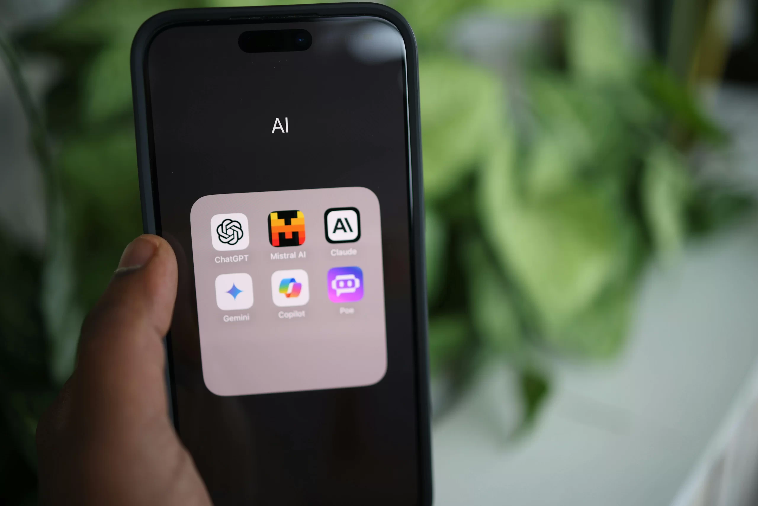 Close-up of a smartphone with major AI applications on screen.