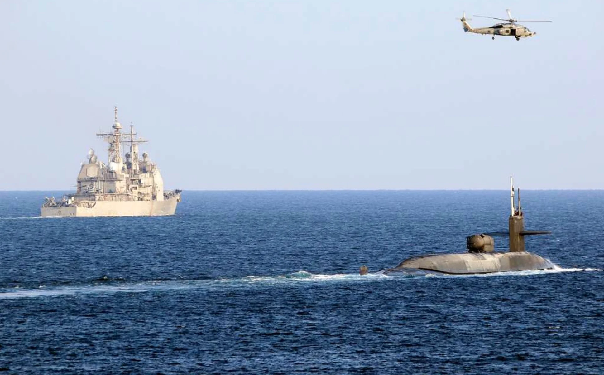 The guided-missile submarine USS Georgia (SSGN 729), right, transits the Strait of Hormuz with the guided-missile cruiser USS Port Royal (CG 73). (Dec. 21, 2020)