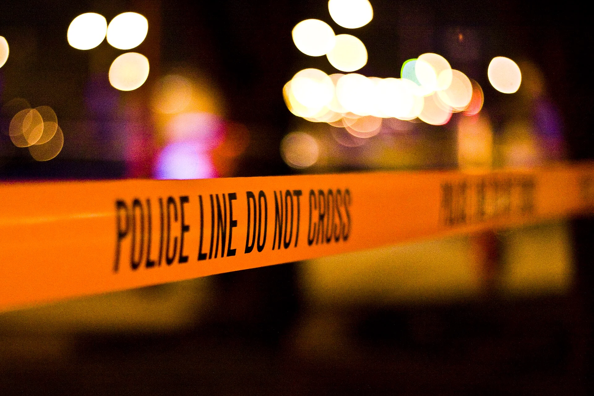 A police line (Crime-scene-do-not-cross sign).