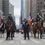 Mounted police officers in a city parade, displaying security and community presence. New York City, USA.