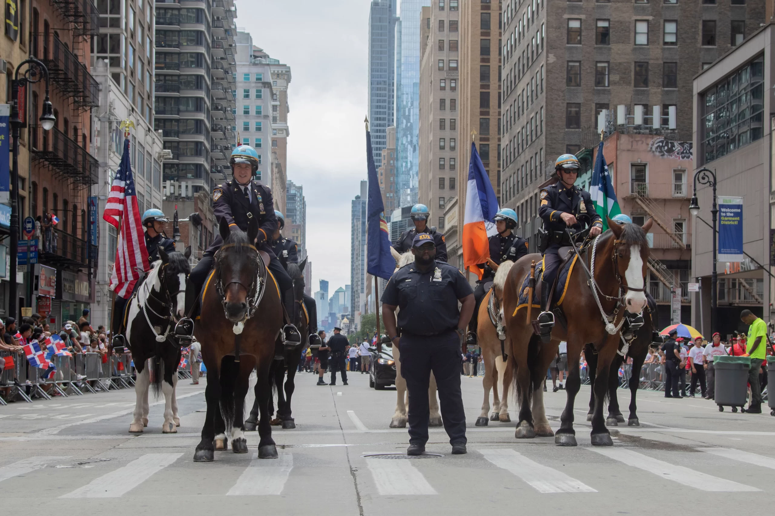 Mounted police officers in a city parade, displaying security and community presence. New York City, USA.