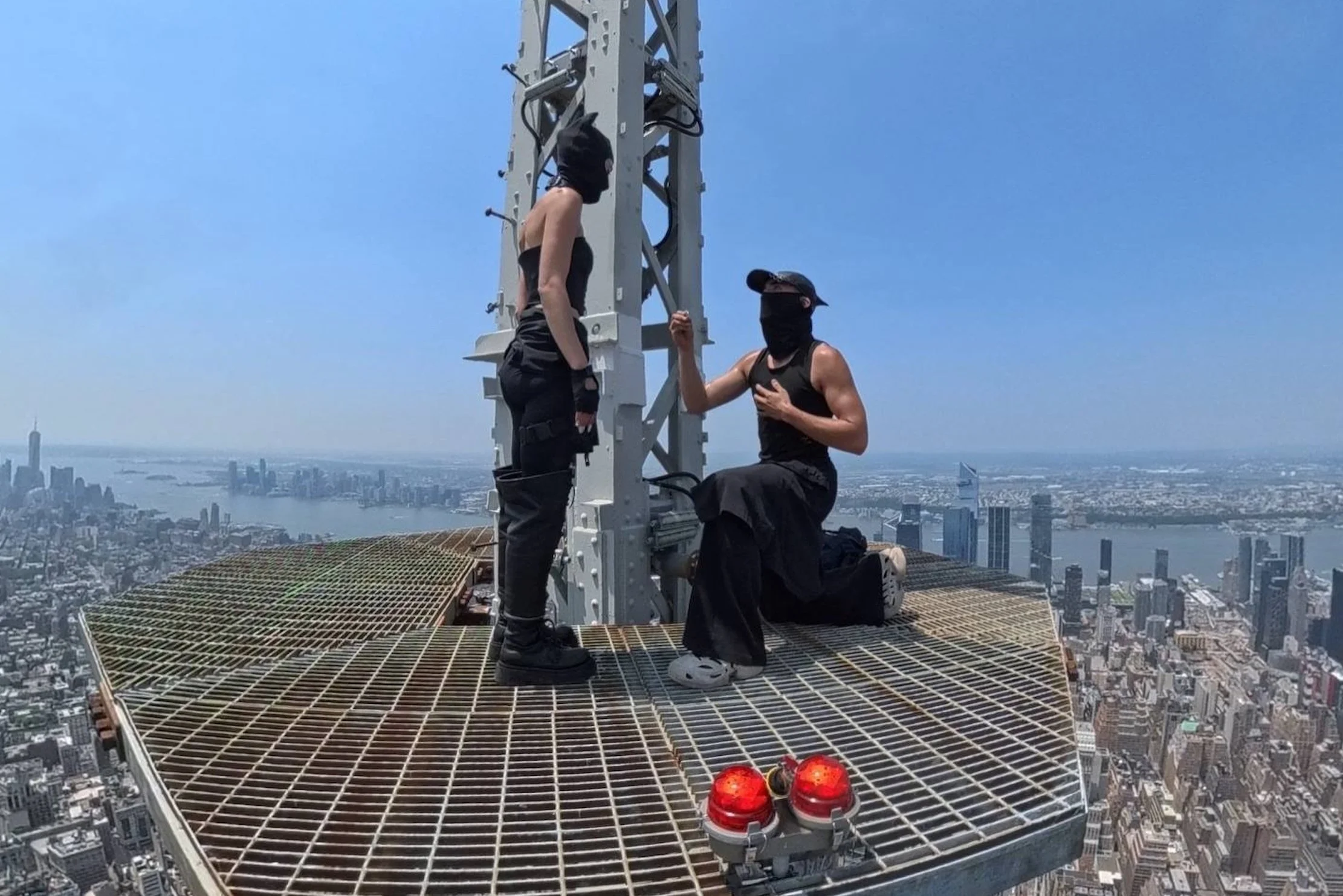Russian rooftop climbers Angela Nikolau and Ivan Beerkus scaled the 1,454-foot spire of New York Citys Empire State Building on July 1, 2026.