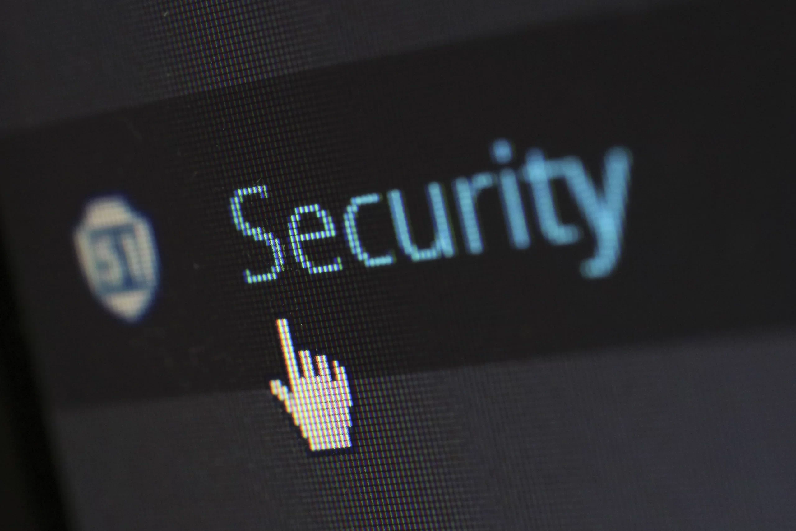 A mouse cursor over digital security text on display.