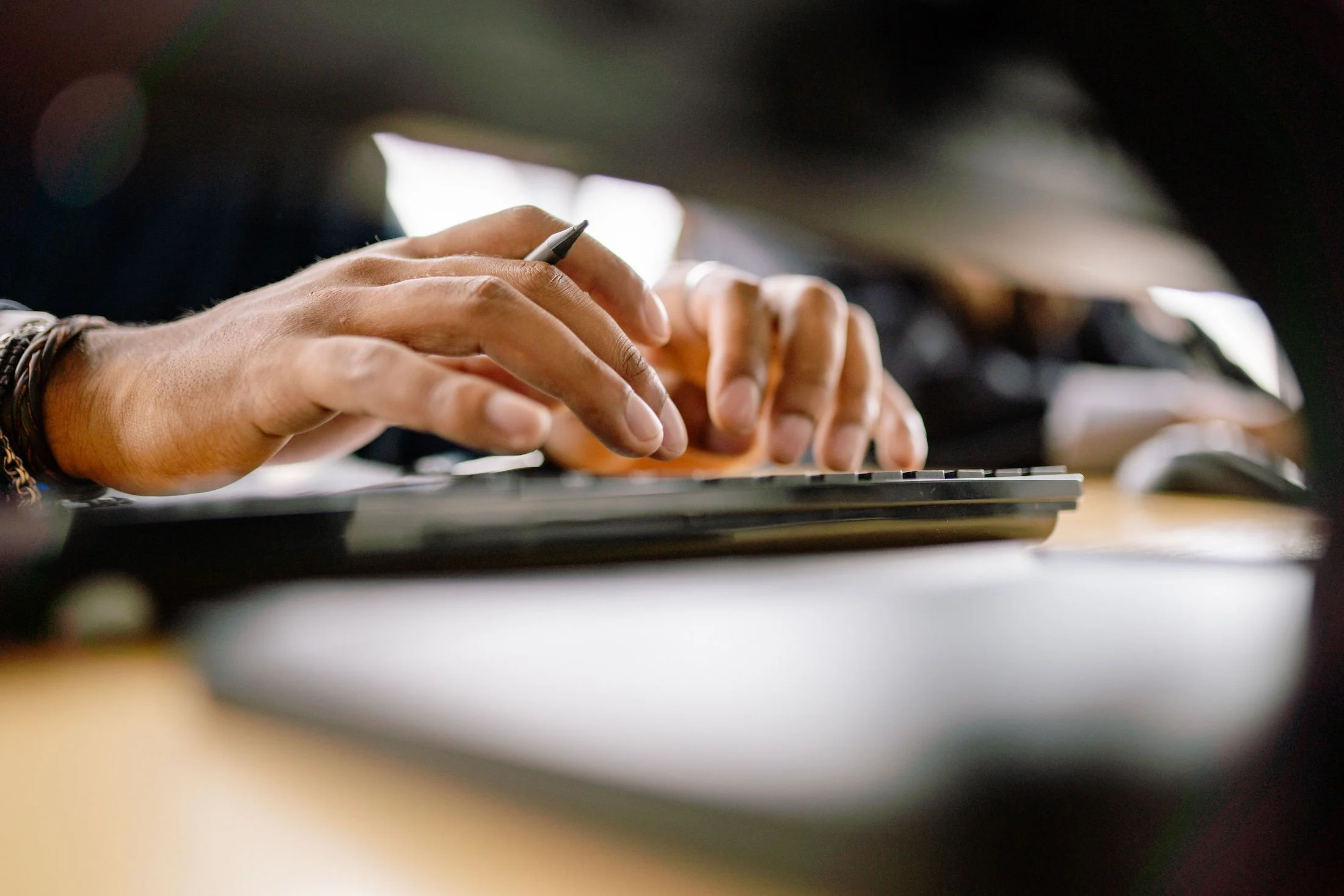 A detailed view of a person typing on a keyboard.