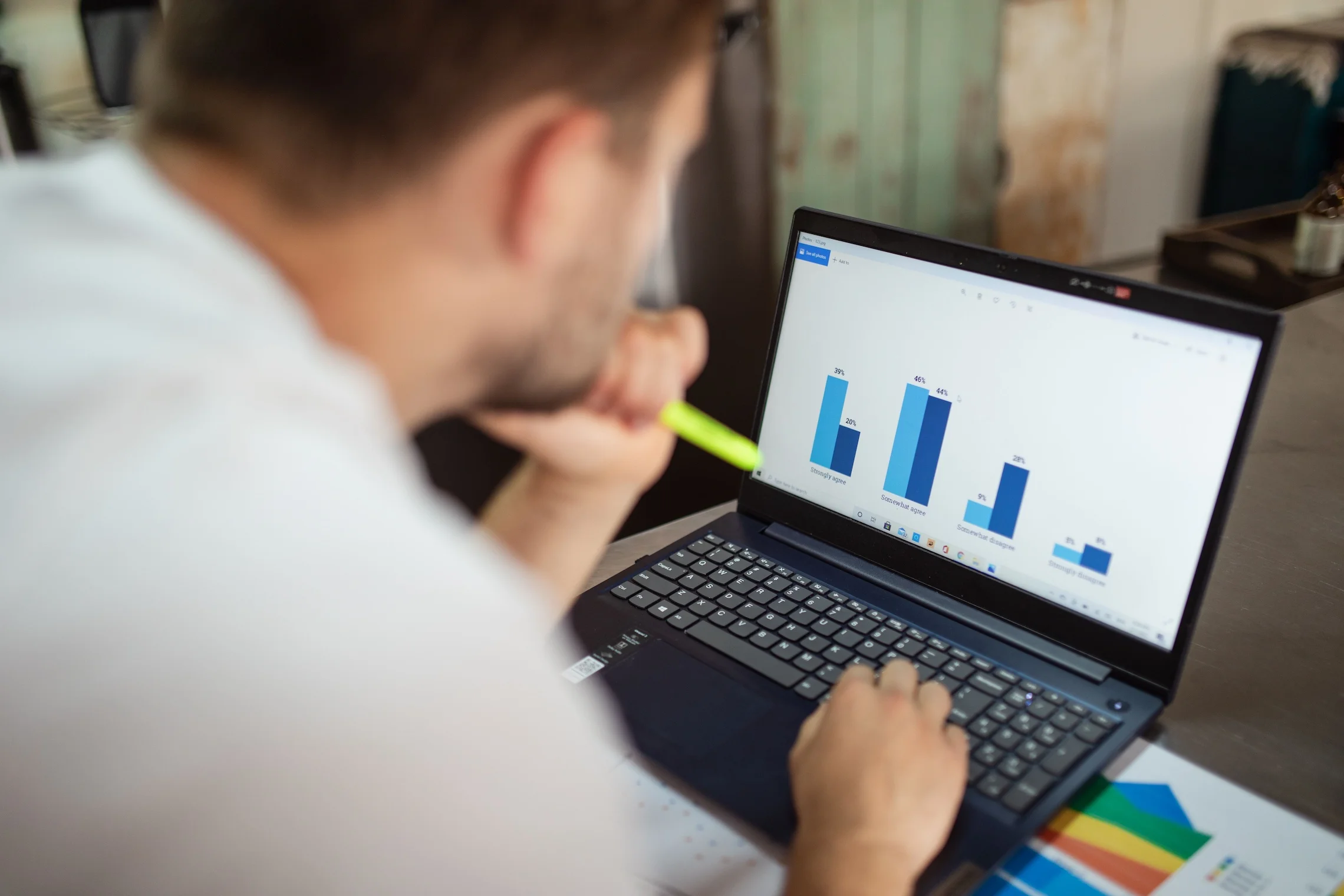Man reviewing business charts on a laptop.